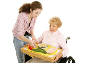 caregiver giving foods to her patient
